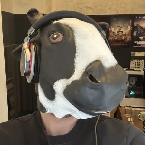 Filip Mašek, the game's maker, in a cow mask and headphones